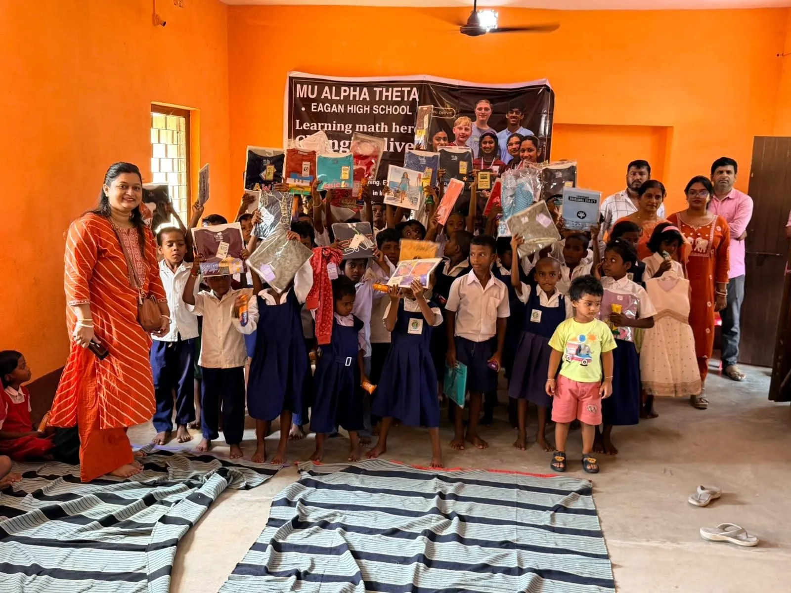Students and volunteers pose together after the distribution